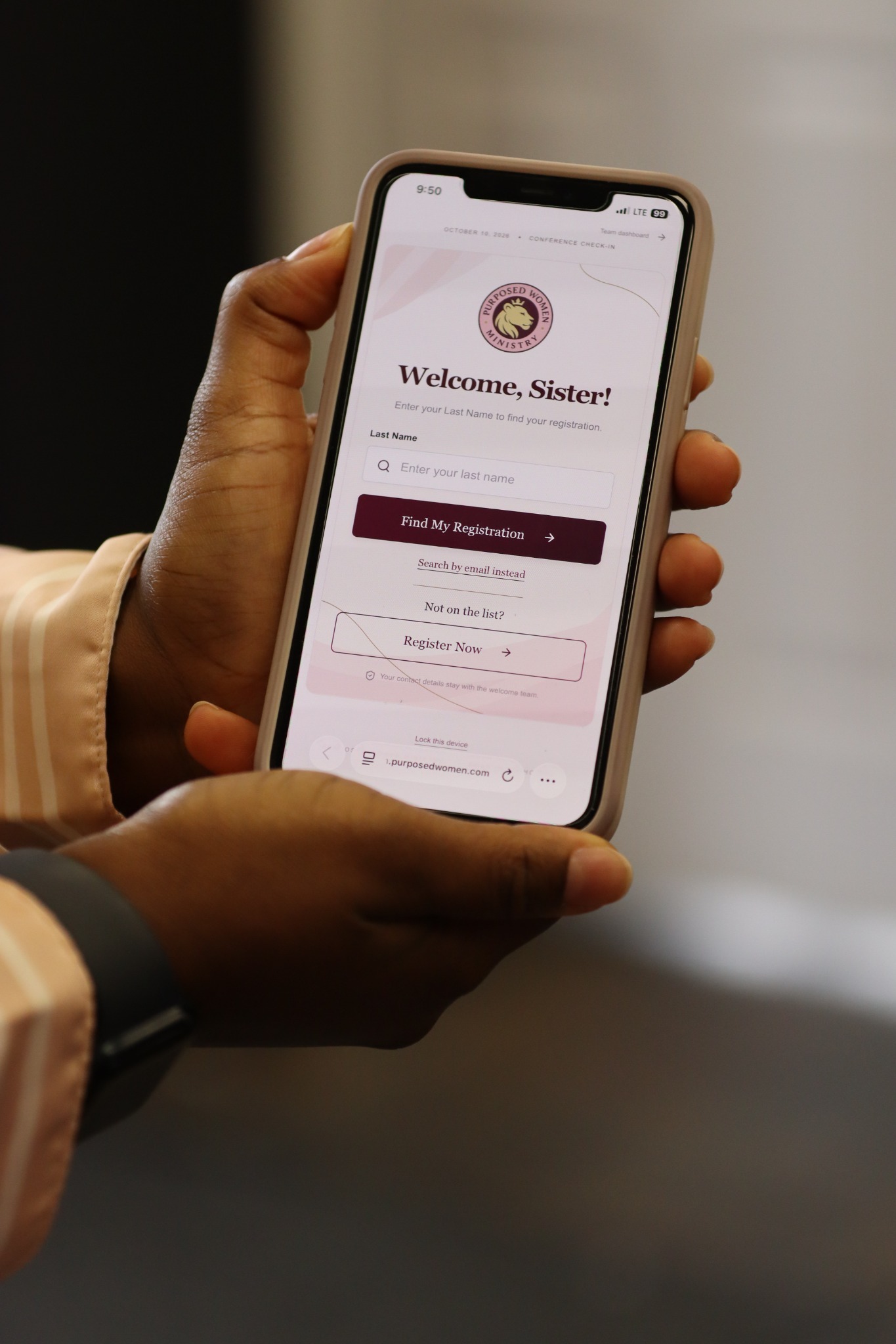 A guest holding a phone displaying the Purposed Women Roar In Authority registration lookup screen